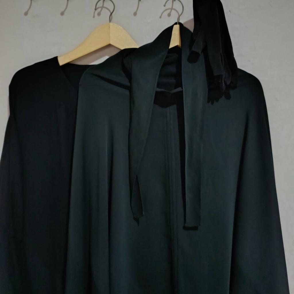 Black garments on wooden hangers