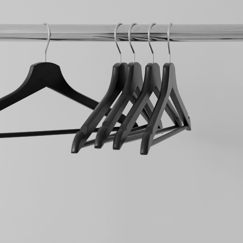Empty clothes hangers on a rail