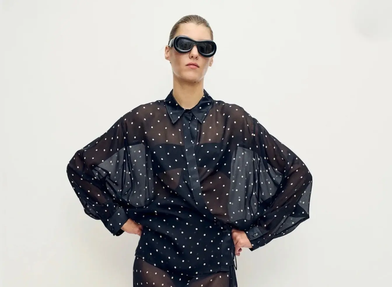 Editorial fashion portrait in black polka-dot styling for Mirra Concierge