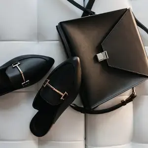 Styled black leather shoes and handbag pairing