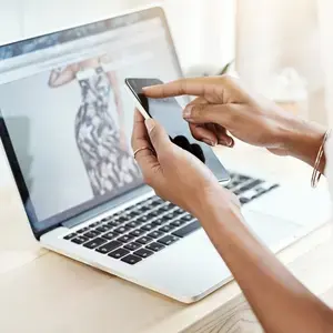 Shopper reviewing styling content on phone and laptop