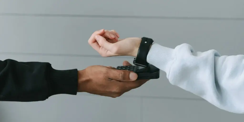 Customer paying with a smartwatch at a contactless payment terminal